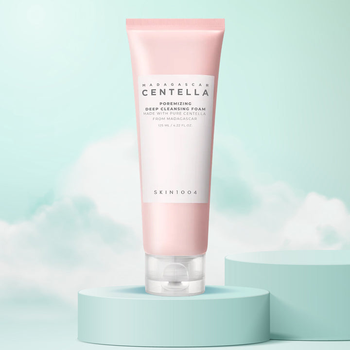 Pink skincare foam tube with 'Skin1004' branding on a light blue background