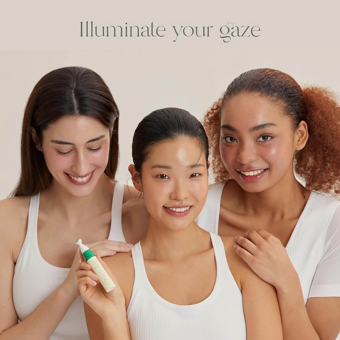 Three women holding a skincare product with text 'Illuminate your gaze' on a beige background