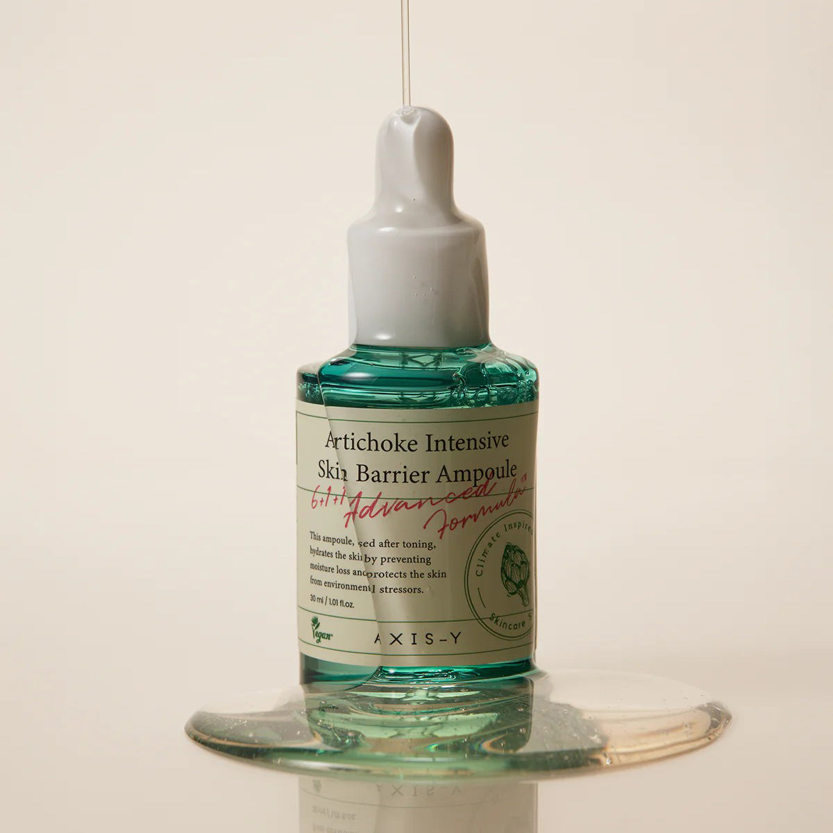 Bottle of Artichoke Intensive Skin Barrier Ampoule on a beige background