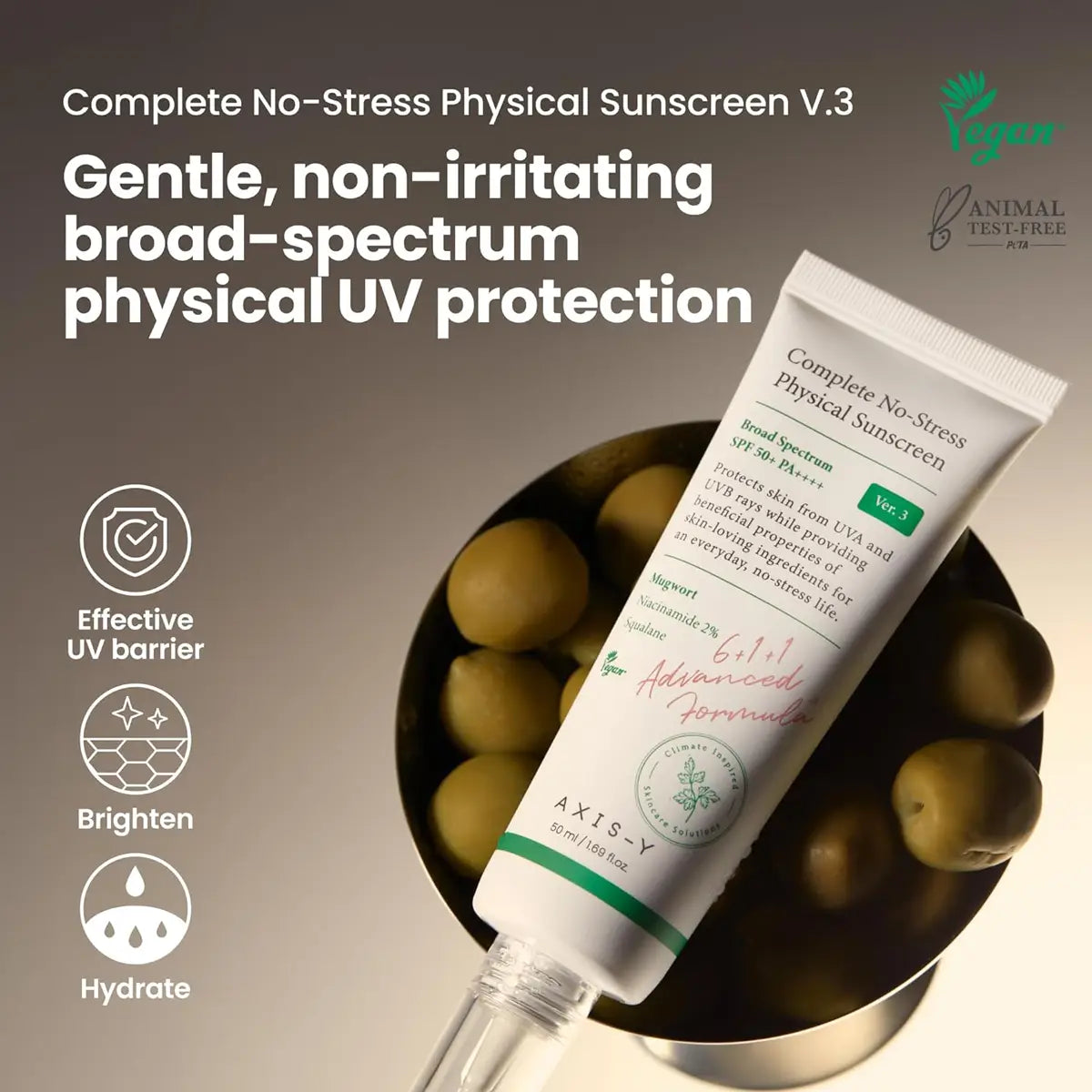 Tube of Axis-Y Complete No-Stress Physical Sunscreen V.3 with olives in the background