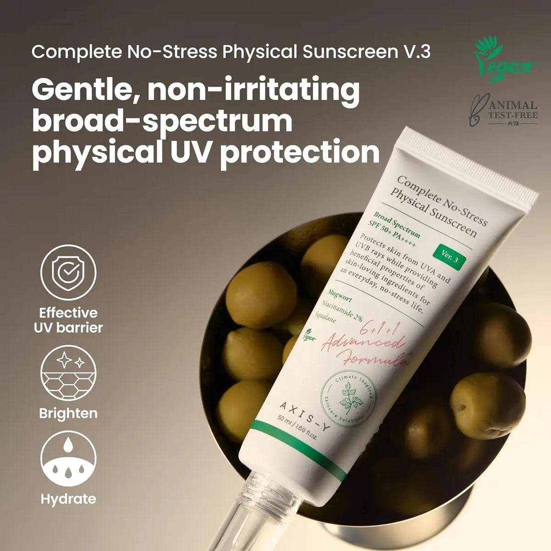 Tube of Axis-Y Complete No-Stress Physical Sunscreen V.3 with olives in the background