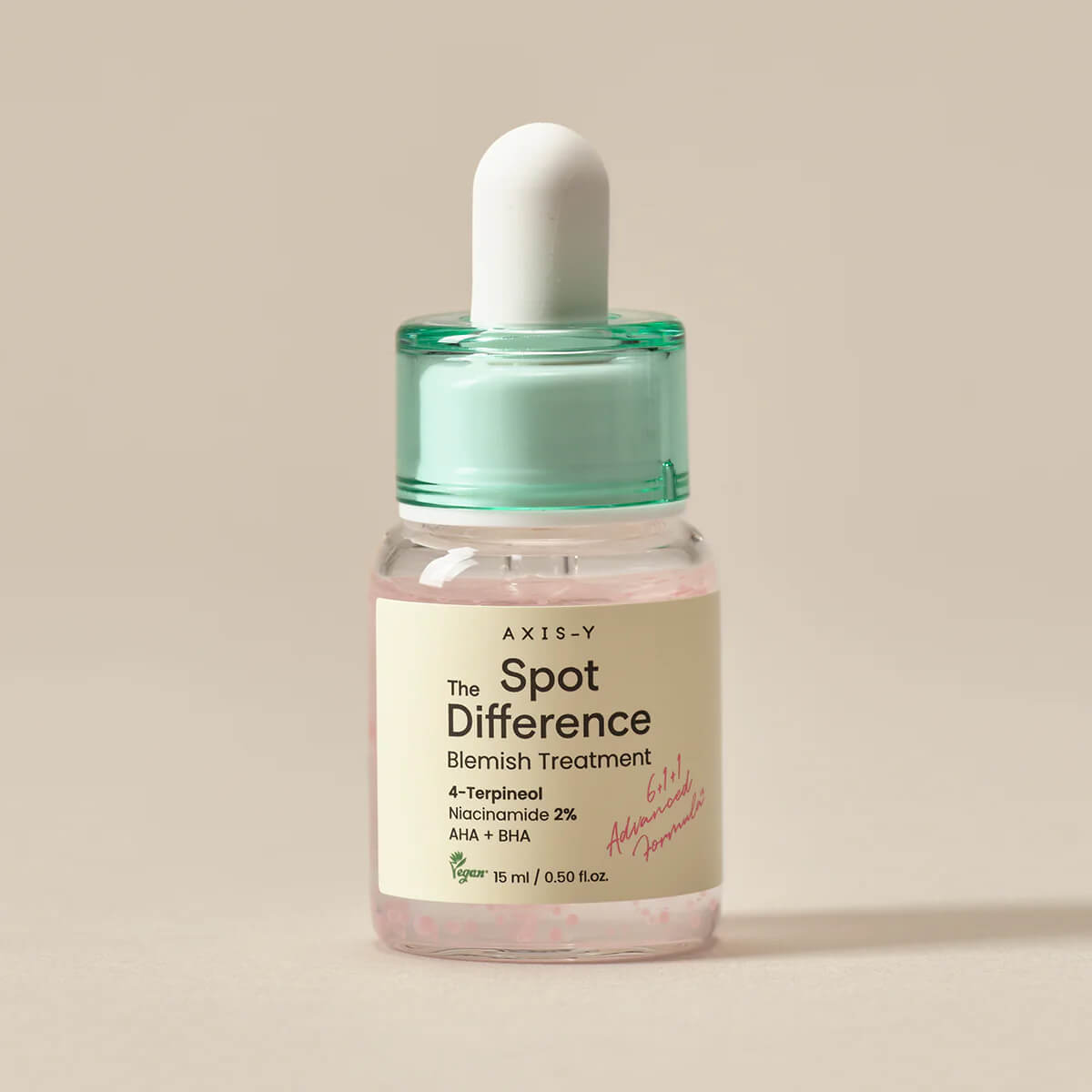 Bottle of Axis-Y Spot Difference Blemish Treatment on a beige background