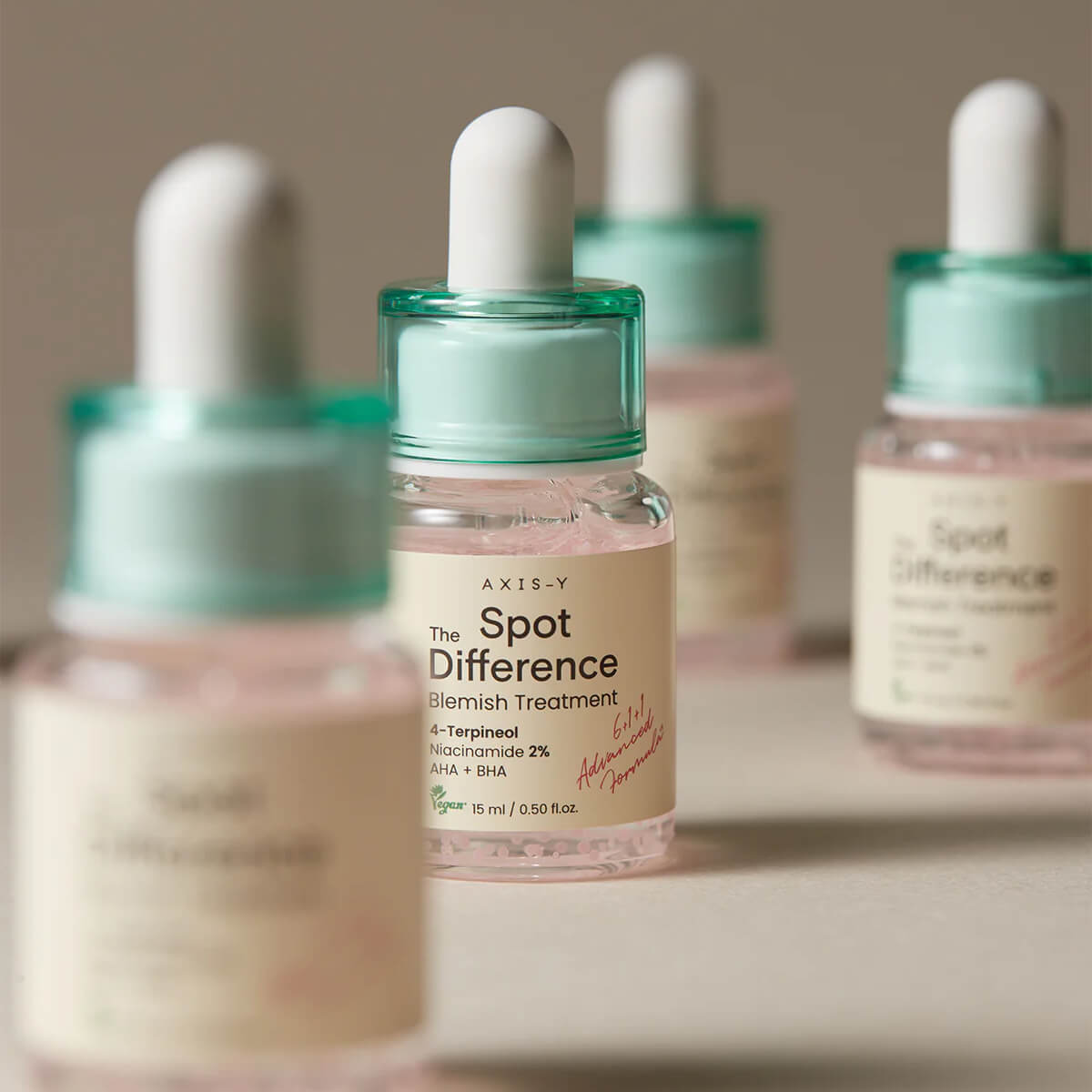 Bottle of AXIS-Y skincare product with dropper on a neutral background