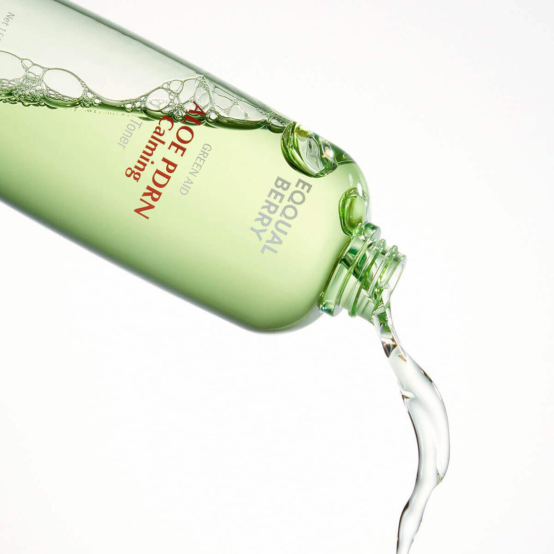 Aloe PDRN calming toner bottle with liquid pouring out, showcasing the soothing qualities of the product.