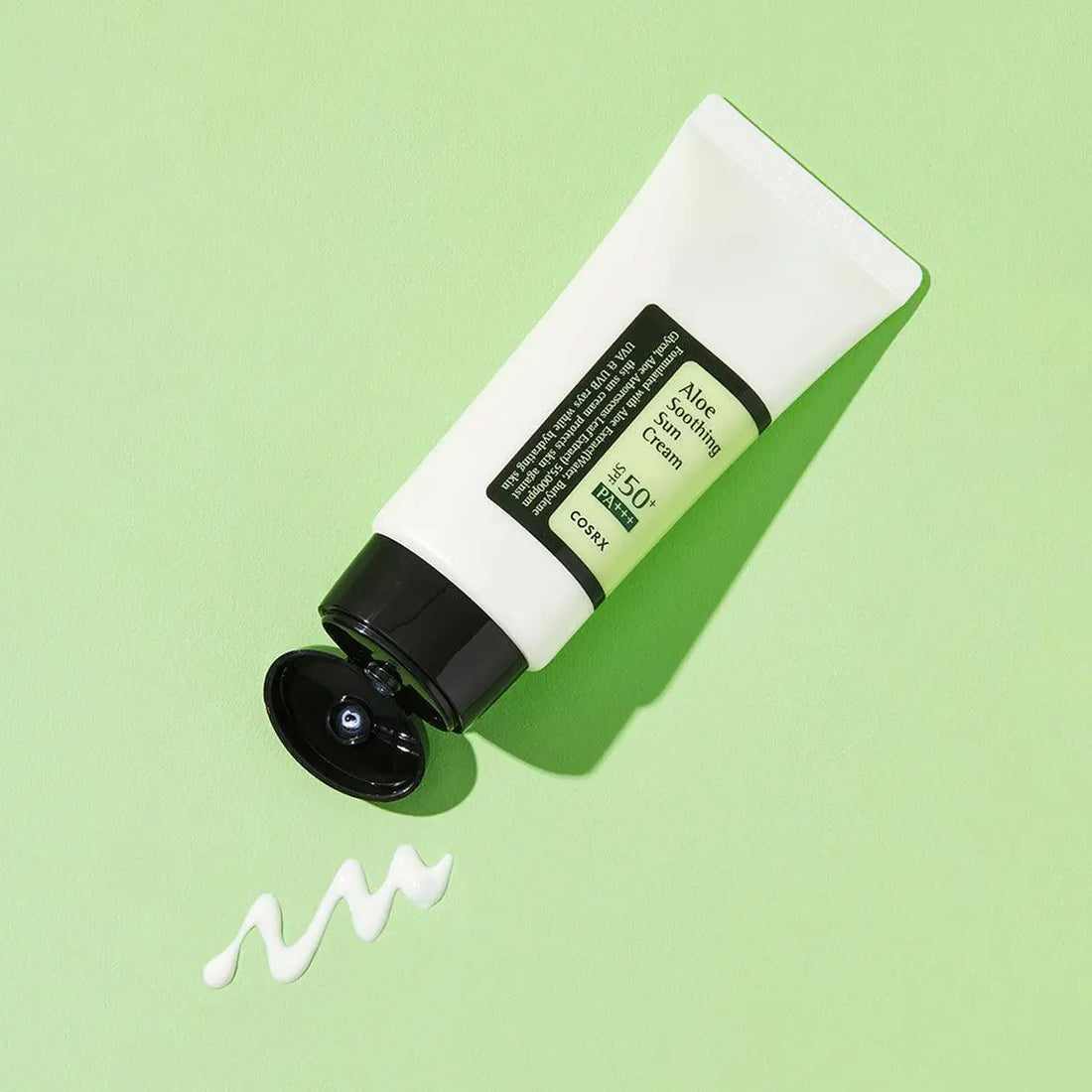 Tube of aloe soothing sun cream on a green background