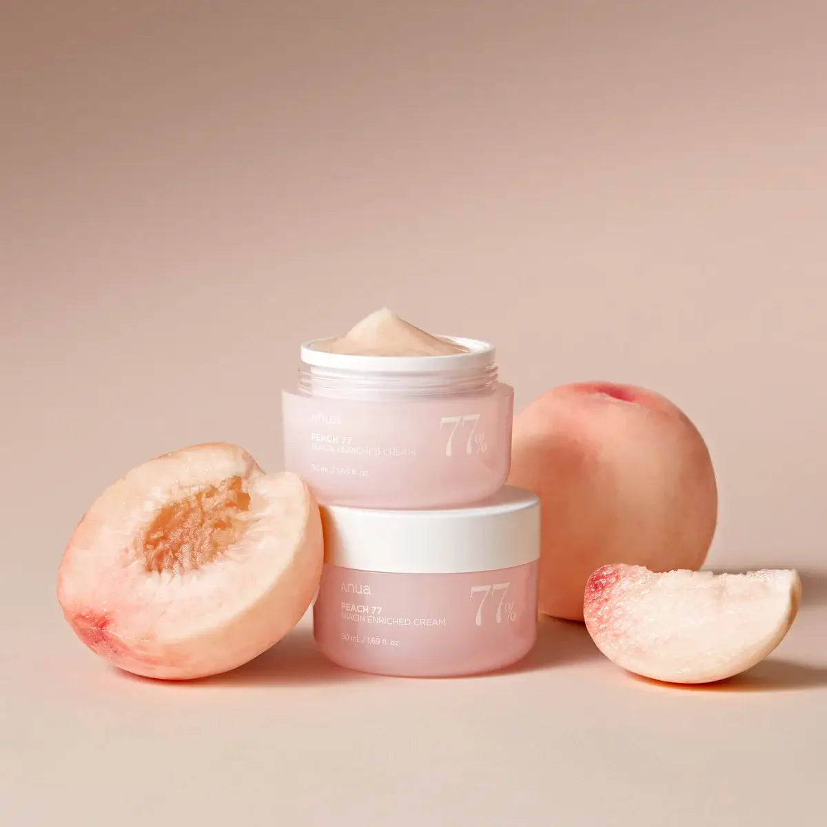 Two jars of skincare product with peaches on a beige background