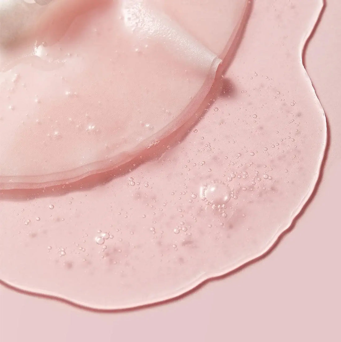 Close-up of pink skincare product on skin