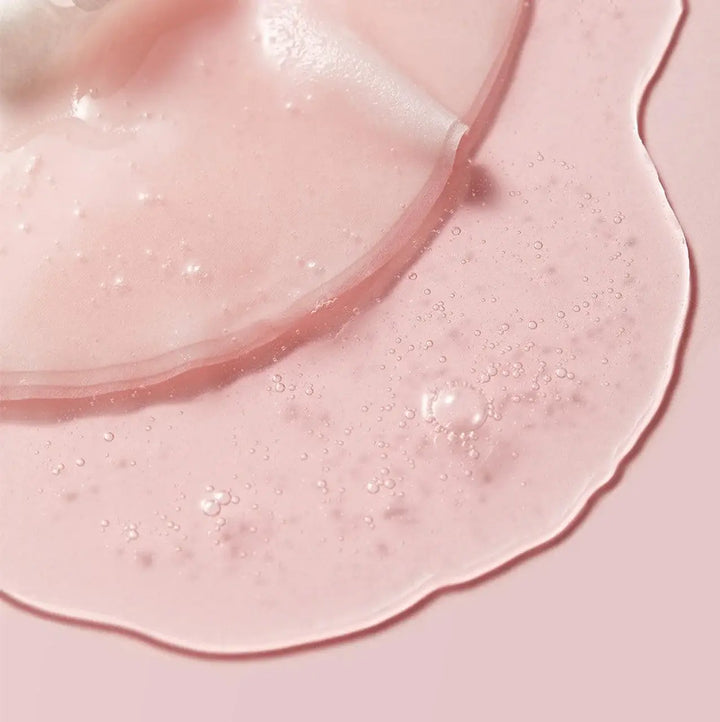 Close-up of pink skincare product on skin