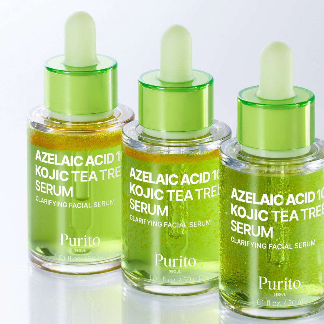 Three bottles of Purito Azelaic Acid 10 Kojic Tea Tree Serum on a white background