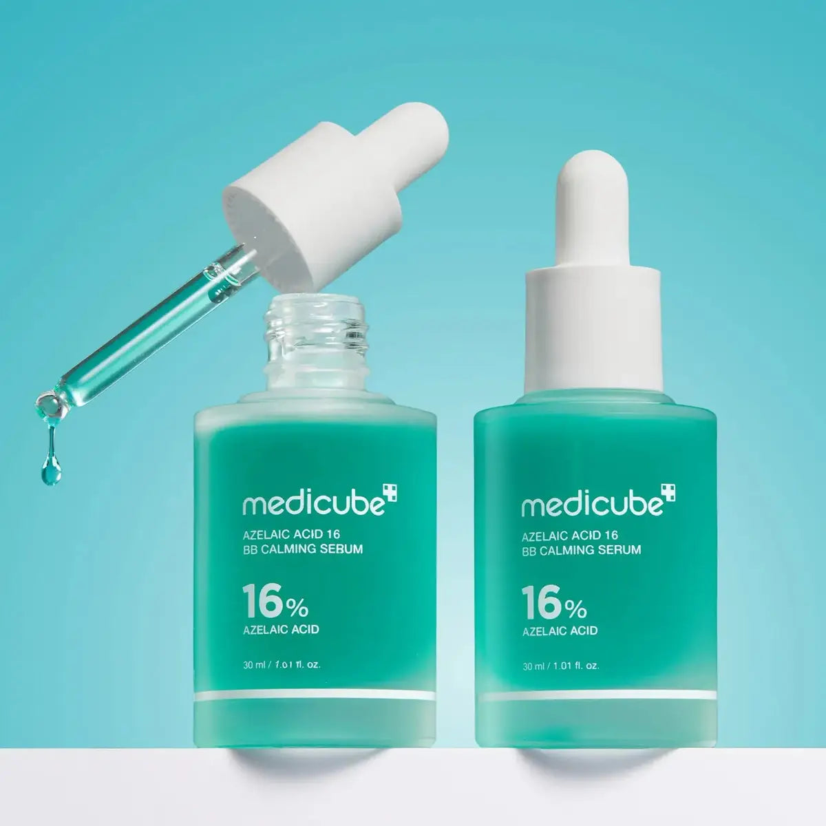 Two bottles of Medicube 16% Azelaic Acid Serum on a light blue background