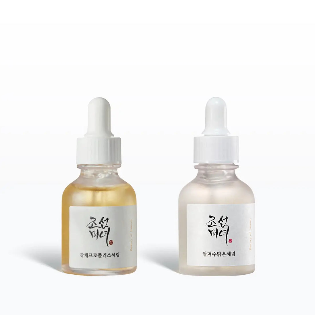 Two skincare serum bottles with droppers on a white background