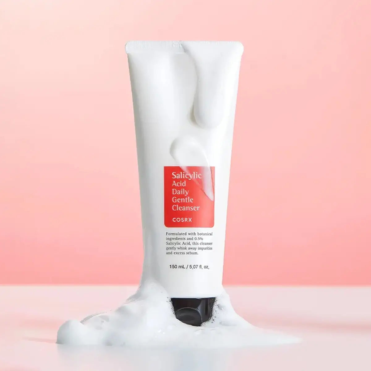 Cosrx Salicylic Acid Daily Gentle Cleanser tube on a pink background