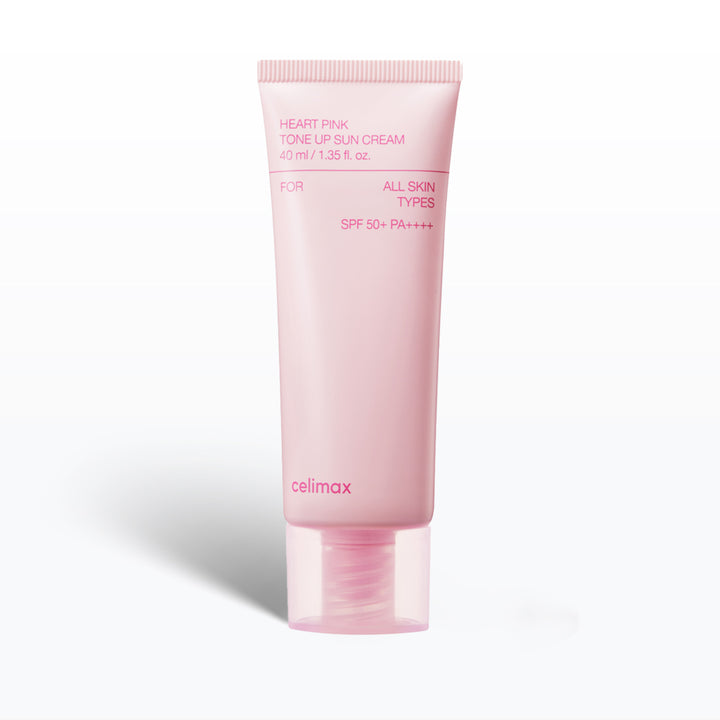 Pink tube of celimax sunscreen cream on a white background