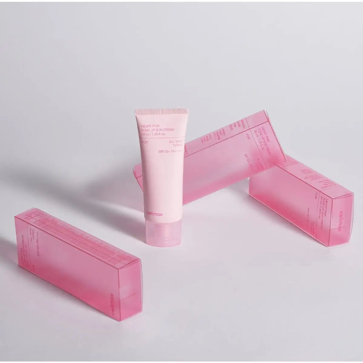 Pink Celimax Sunscreen product and packaging on a light gray background