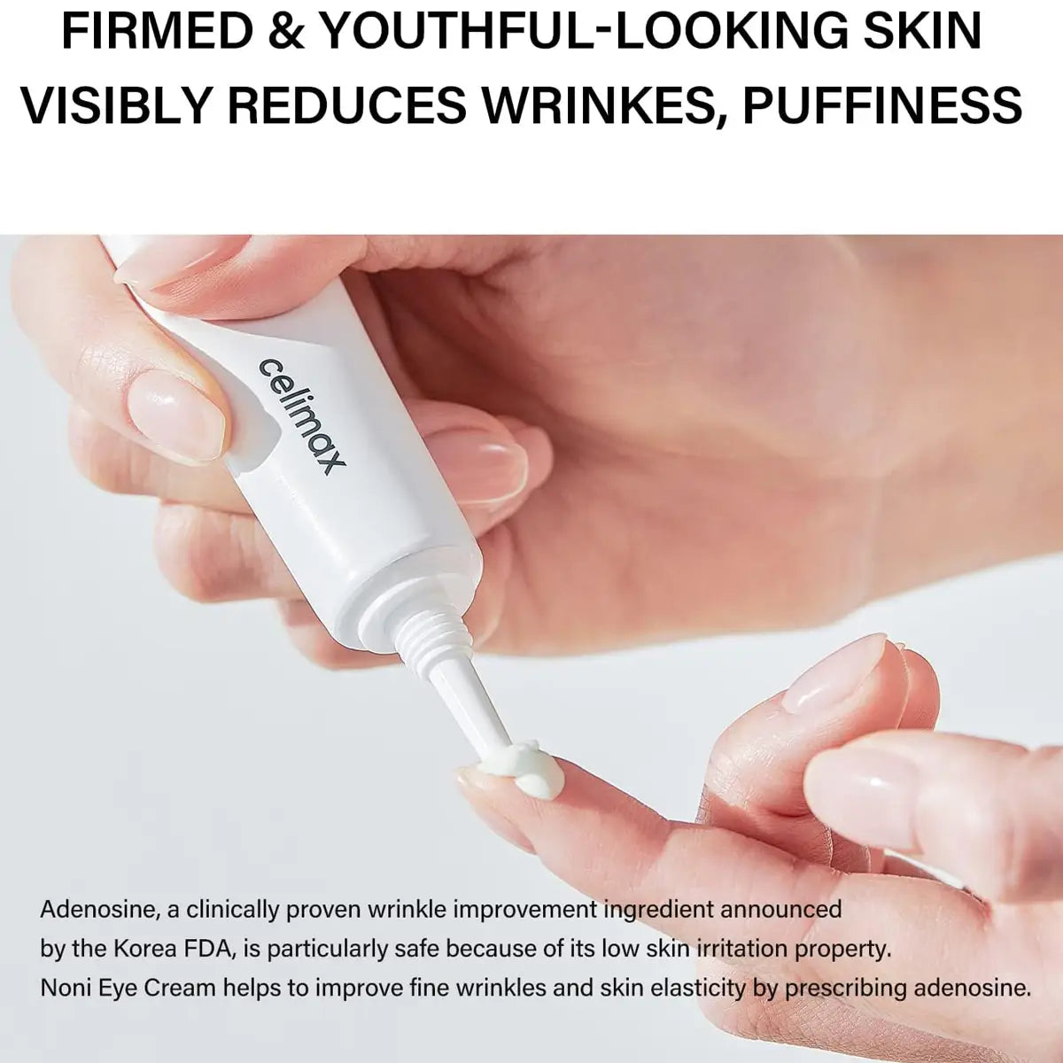 Hand holding a Celimax Noni Ultimate Eye Cream with text about skin care benefits on a light background.