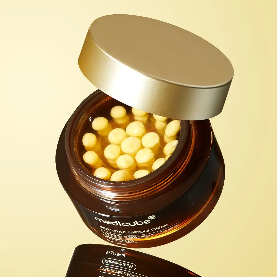 Medicube Deep Vita C Capsule Cream on golden background