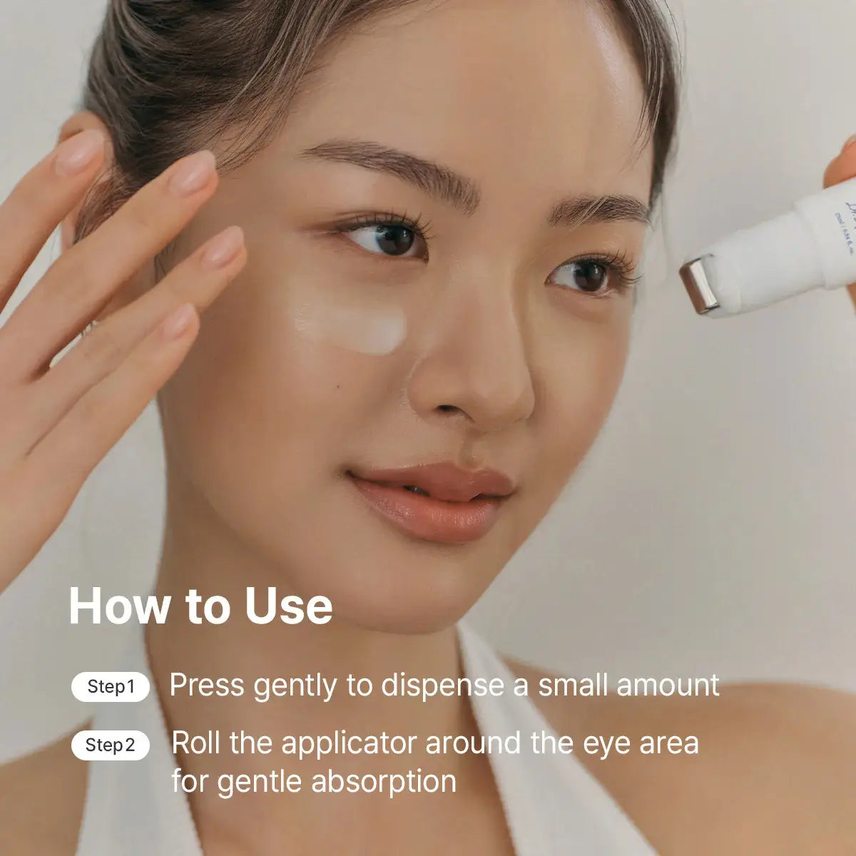 User applying Dr. Althea Retinol Flat Iron Eye Roller 25mL under the eyes for refreshed and smooth appearance.