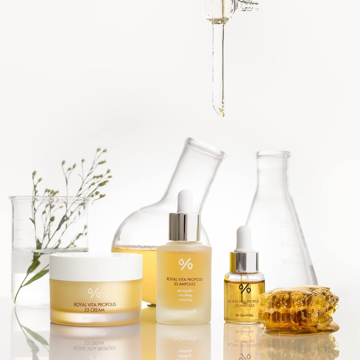 Skincare products including bottles and a jar on a reflective surface with a white background