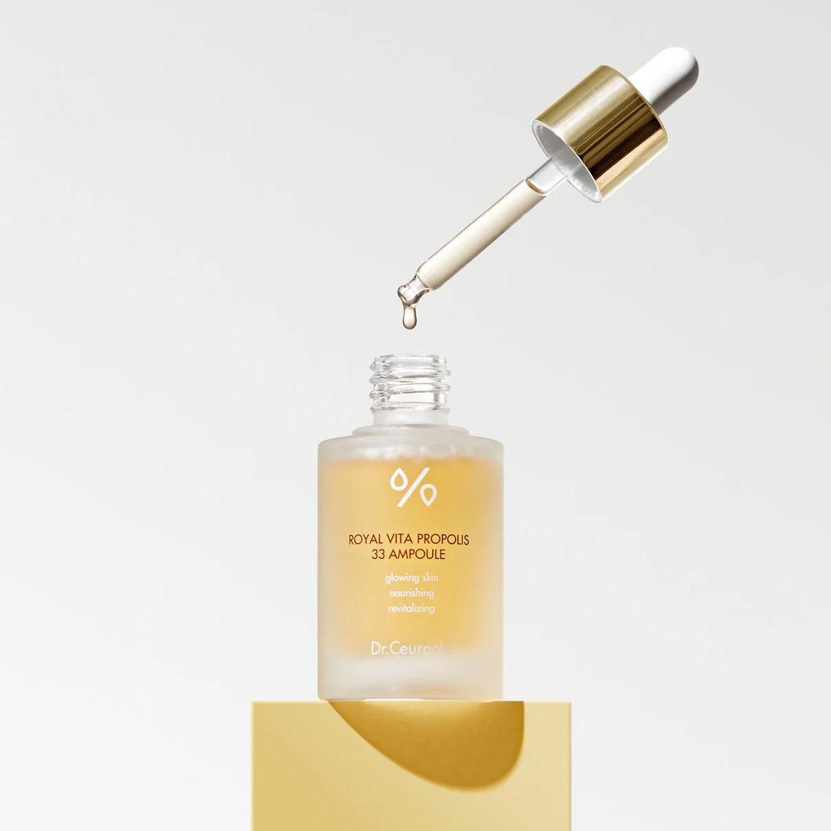 Skincare ampoule with dropper on a light background