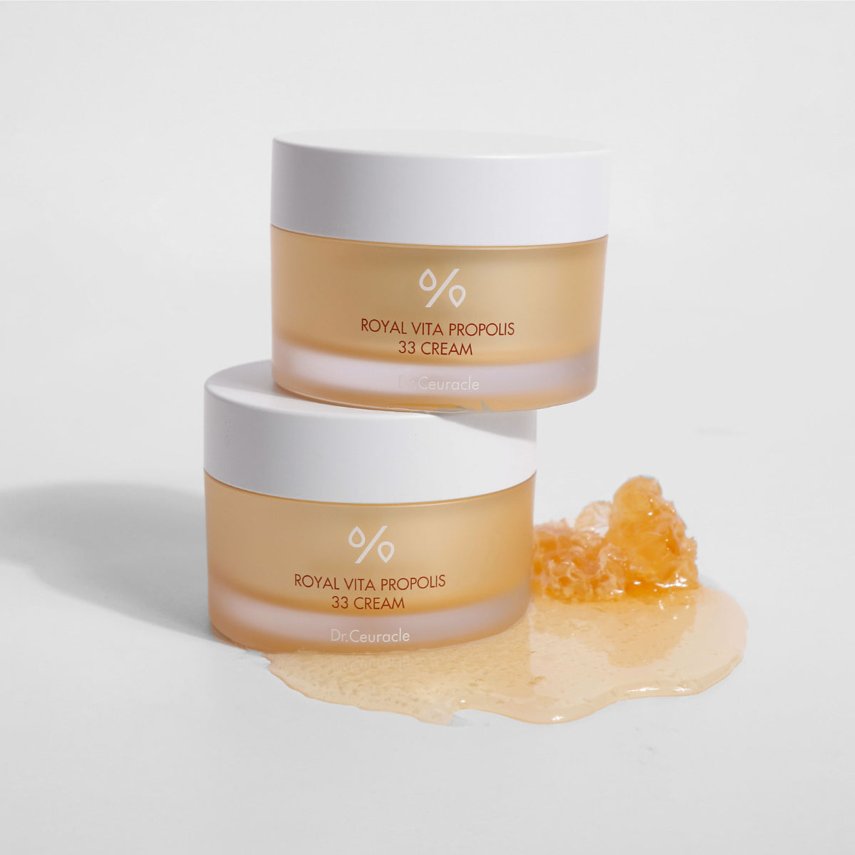 Two jars of 'Royal Vita Propolis 33 Cream' on a light gray background