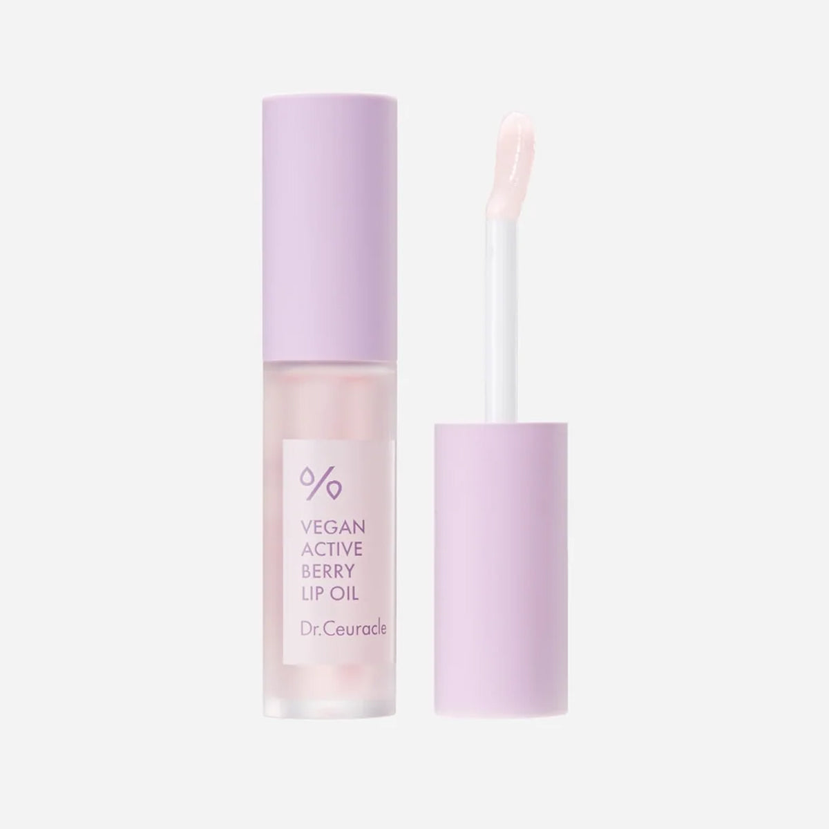 Vegan active berry lip oil with applicator on a light gray background