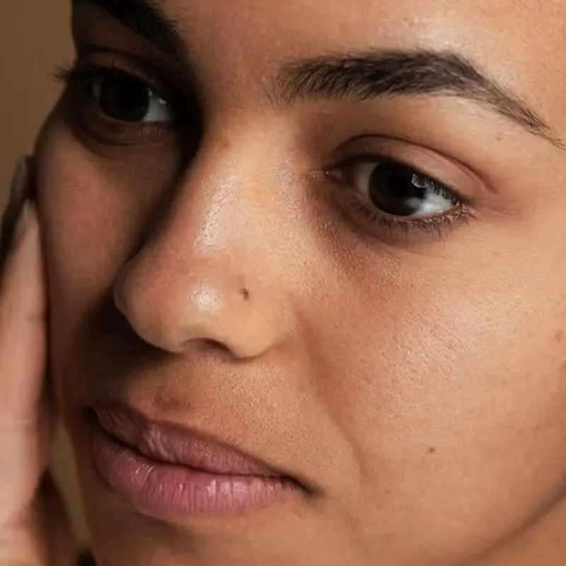 Close-up of a person's face with a dull skin