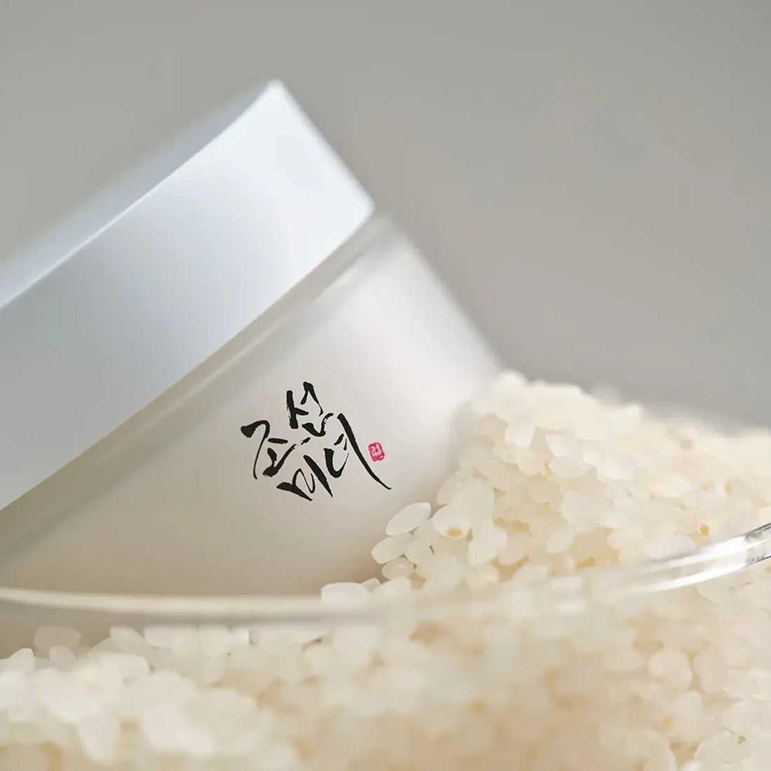 White rice with a white container on a gray background