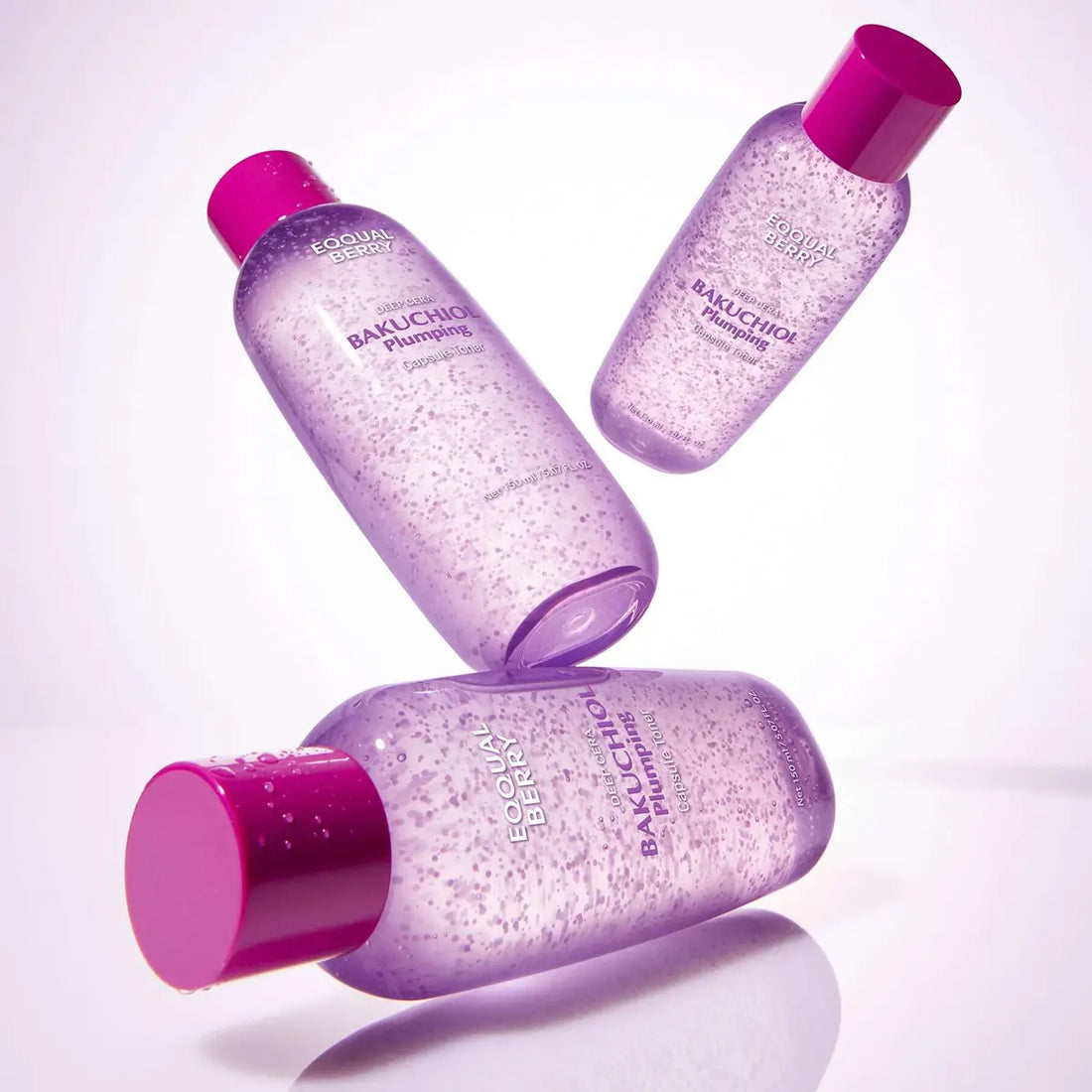 Three Eqqualberry Bakuchiol Plumping Capsule Toner bottles with pink caps on a white background