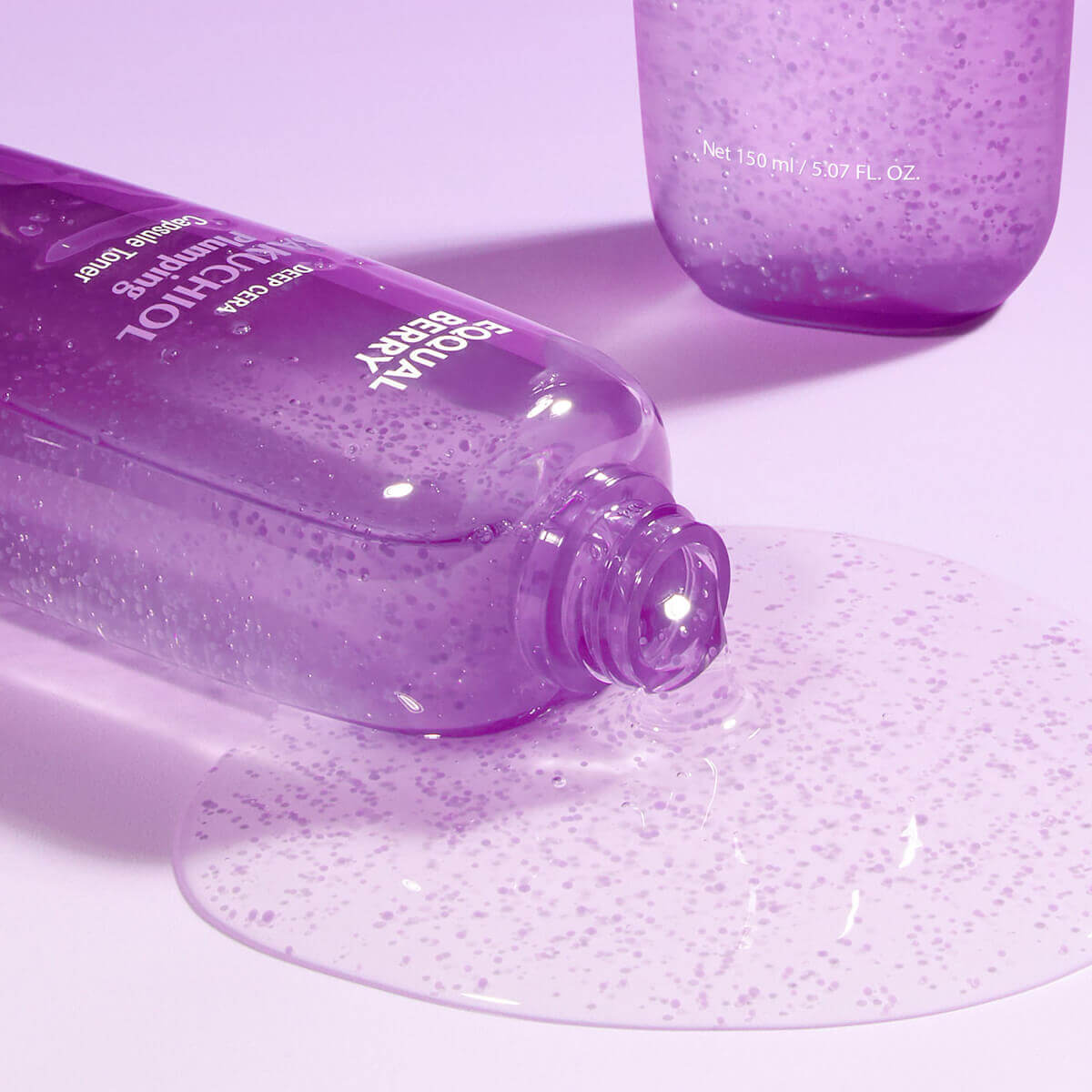 Bakuchiol Plumping Capsule Toner (150mL) bottle with gel spilling, showcasing its texture and vibrant packaging.