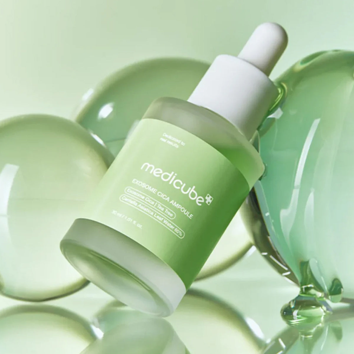 Green skincare bottle with dropper on a green background