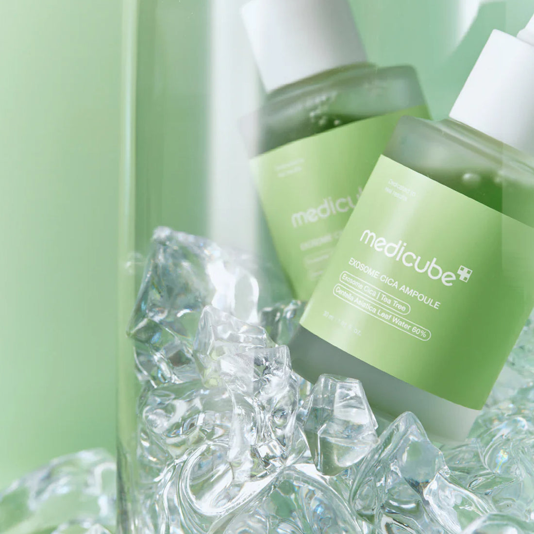 Green skincare ampoules with 'medicube' branding on a green background with ice cubes.