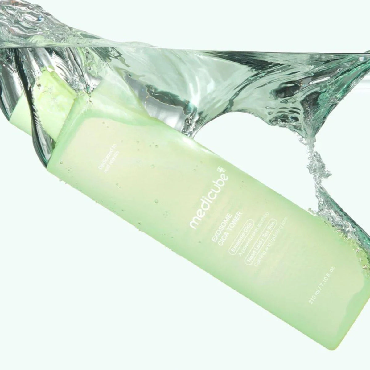 Green bottle with water splash on a white background