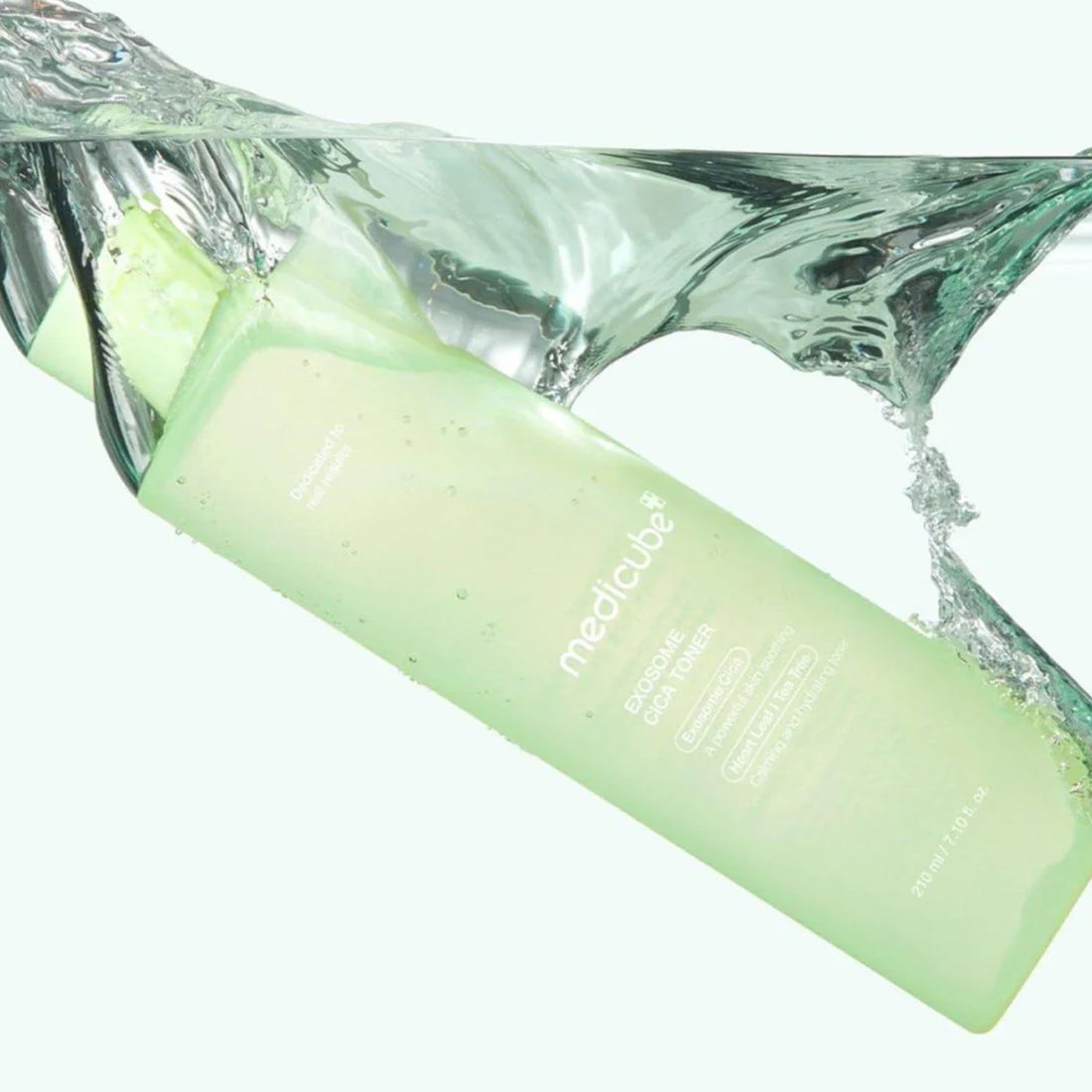 Green bottle with water splash on a white background