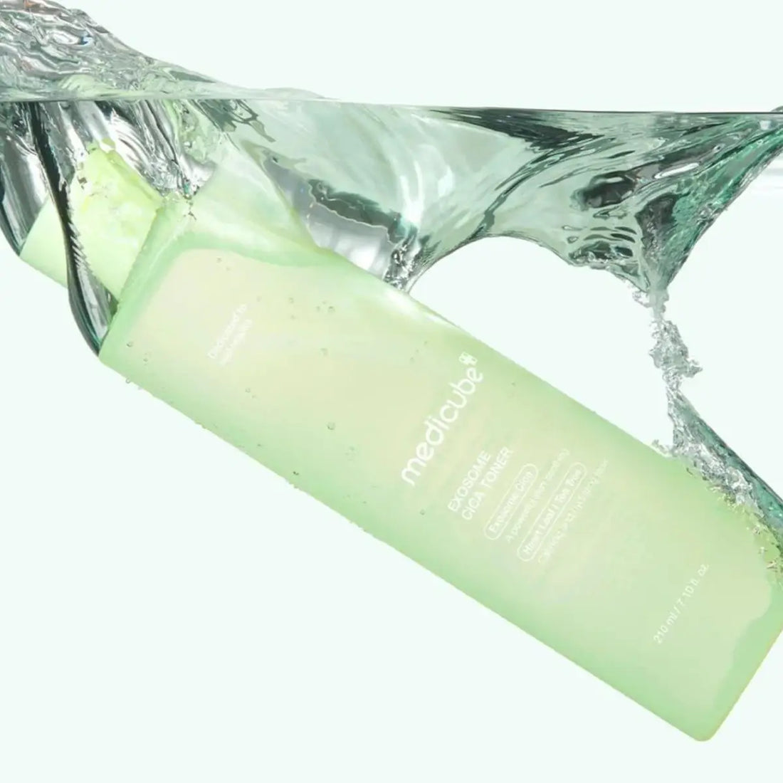 Medicube Exosome Cica Toner with water splashing around it on a white background