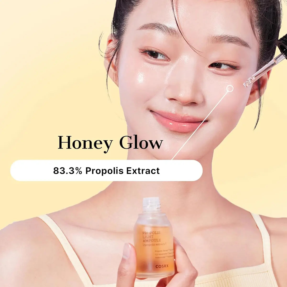 Woman holding a bottle labeled 'Honey Glow' with propolis extract on a yellow background