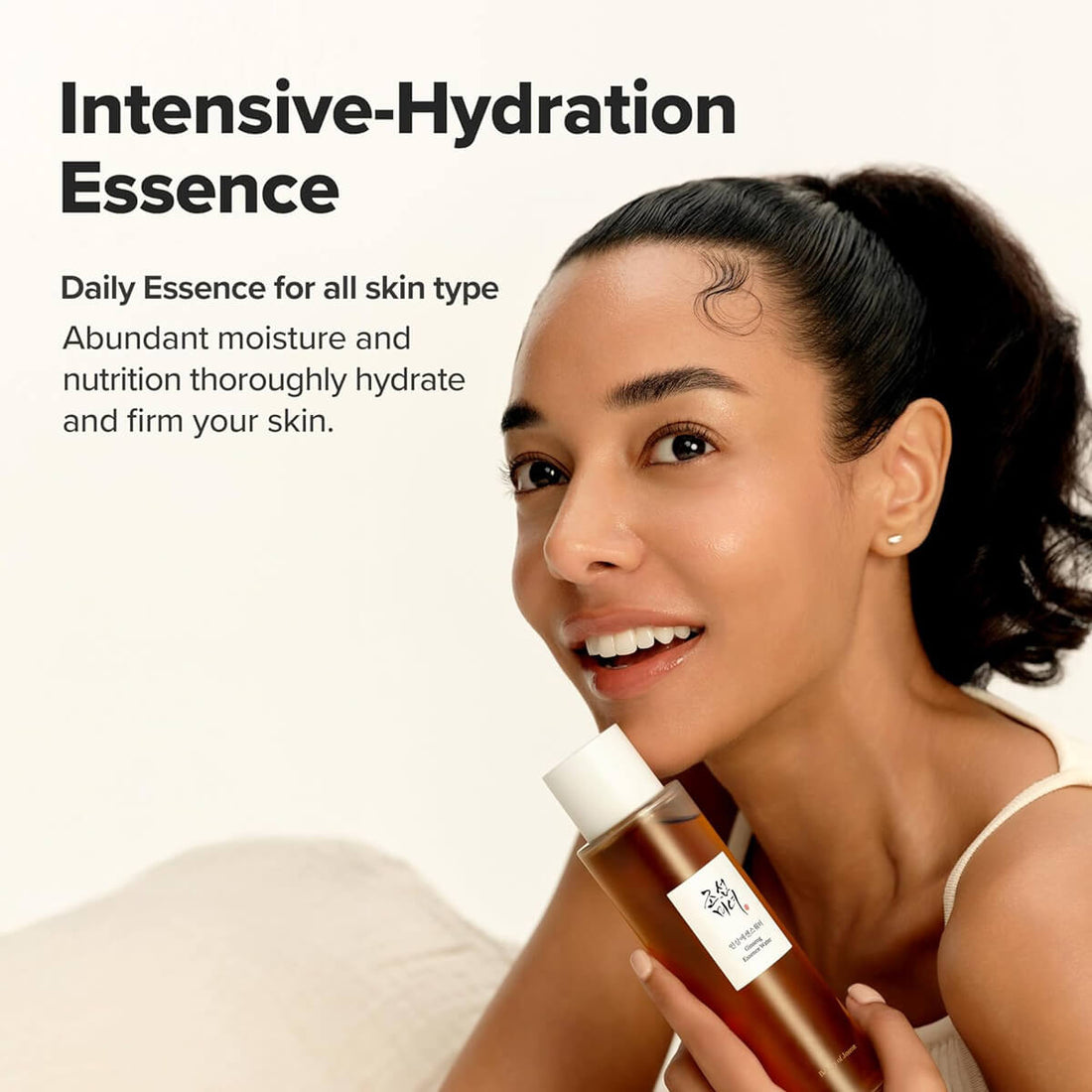 Woman holding a bottle of Intensive-Hydration Essence with text about its benefits.