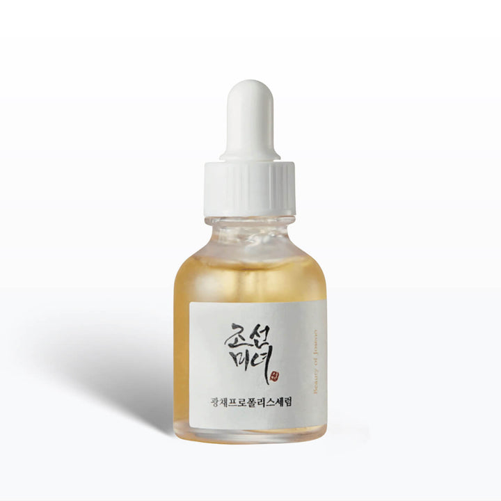 Skincare serum bottle with dropper on a white background