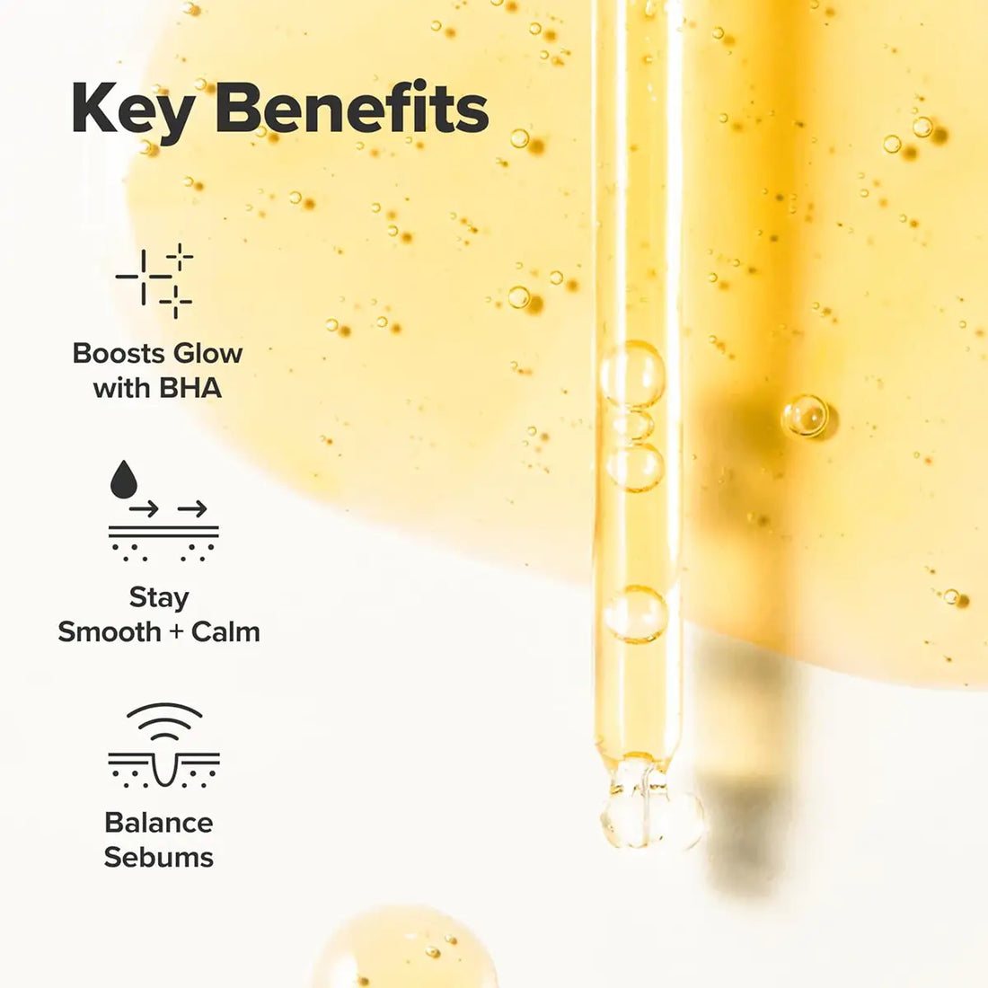 Skincare serum dropper with key benefits text on a white background
