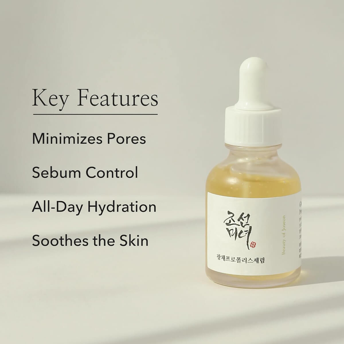 Skincare dropper bottle with key features listed on a light gray background