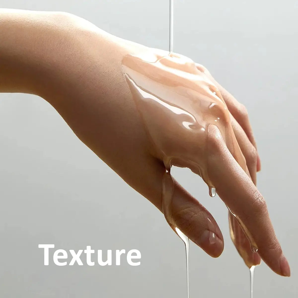 Close-up of hands with water droplets on a neutral background
