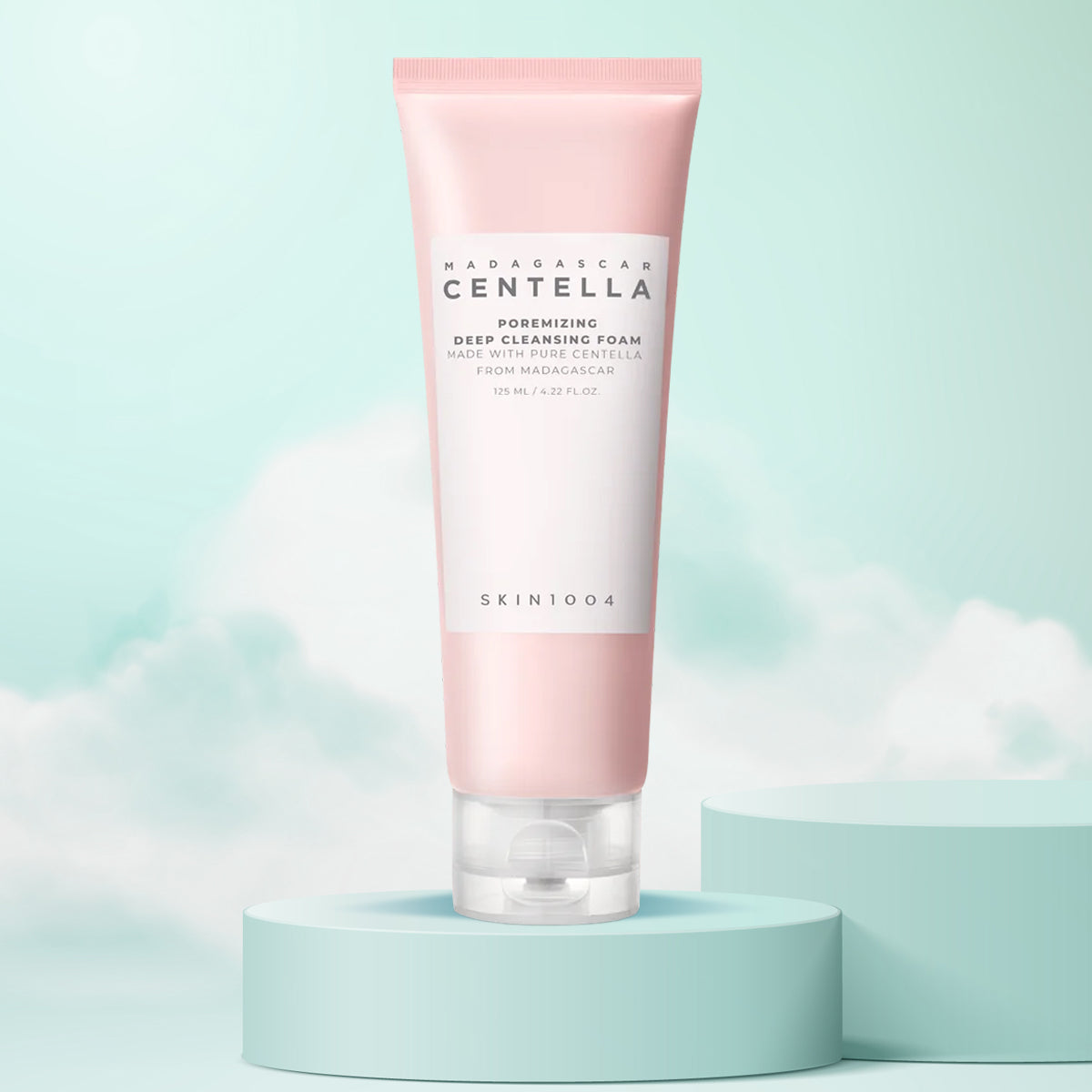 Pink skincare foam tube with 'Skin1004' branding on a light blue background