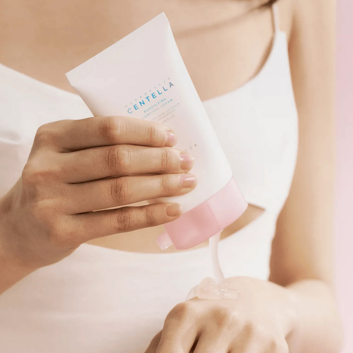 Person applying Centella product to their skin