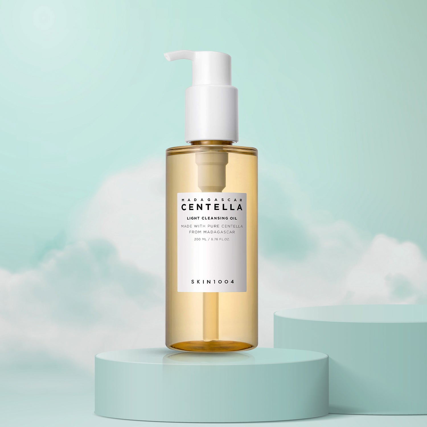A pump bottle of Madagascar Centella Light Cleansing Oil by Skin1004, displayed on a pedestal against a sky blue background.
