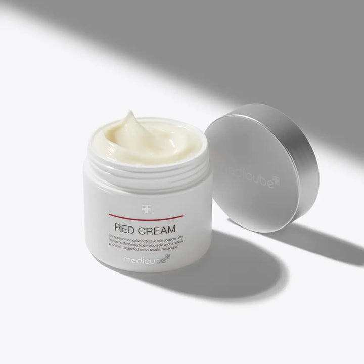 Jar of Red Cream with a white lid on a light gray background