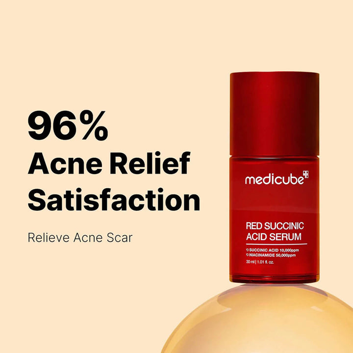 Red succinic acid serum bottle with 'medicube' branding on a beige background