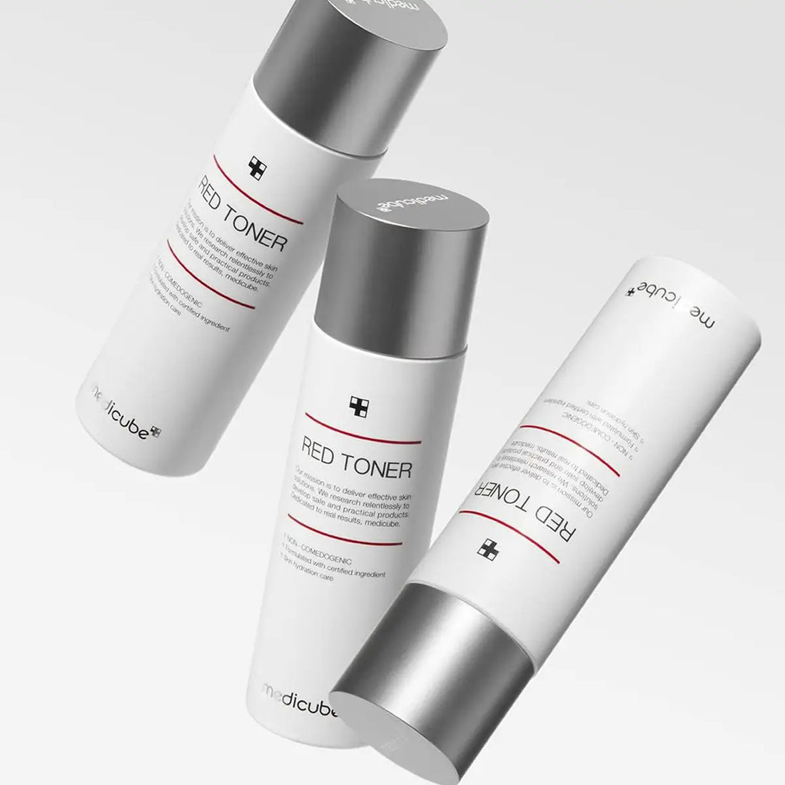 Three bottles of Red Toner by Medicube on a light gray background