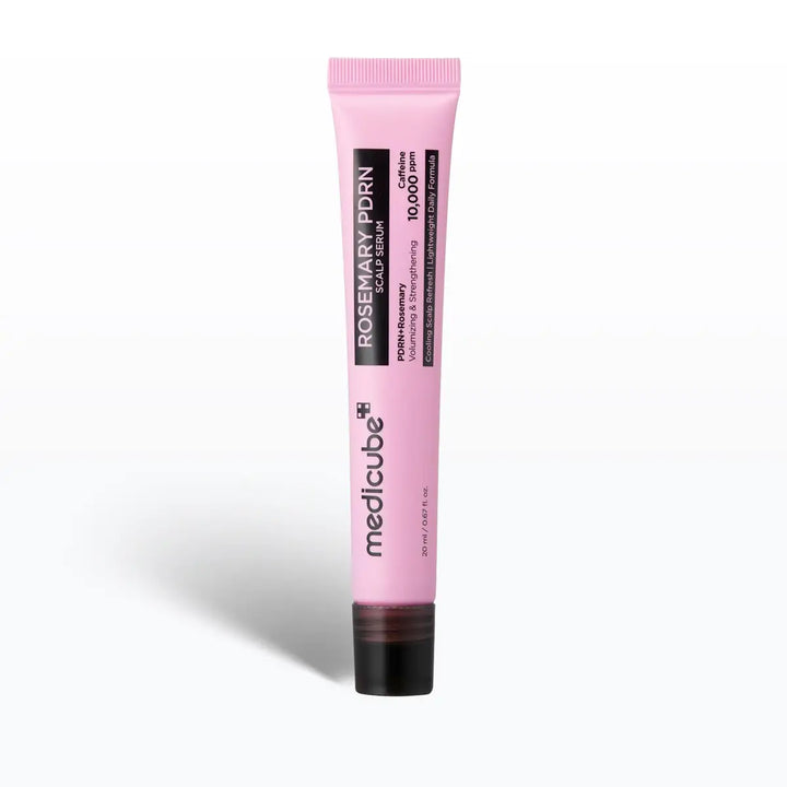 Pink tube of Medicube rosemary porn scalp serum on a white background