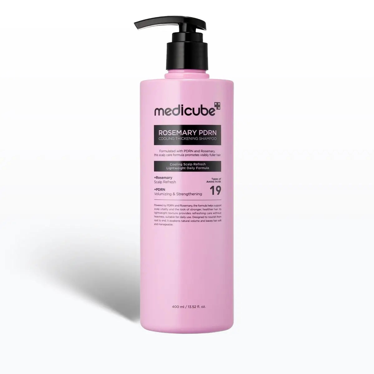 Pink shampoo bottle with black pump on a white background