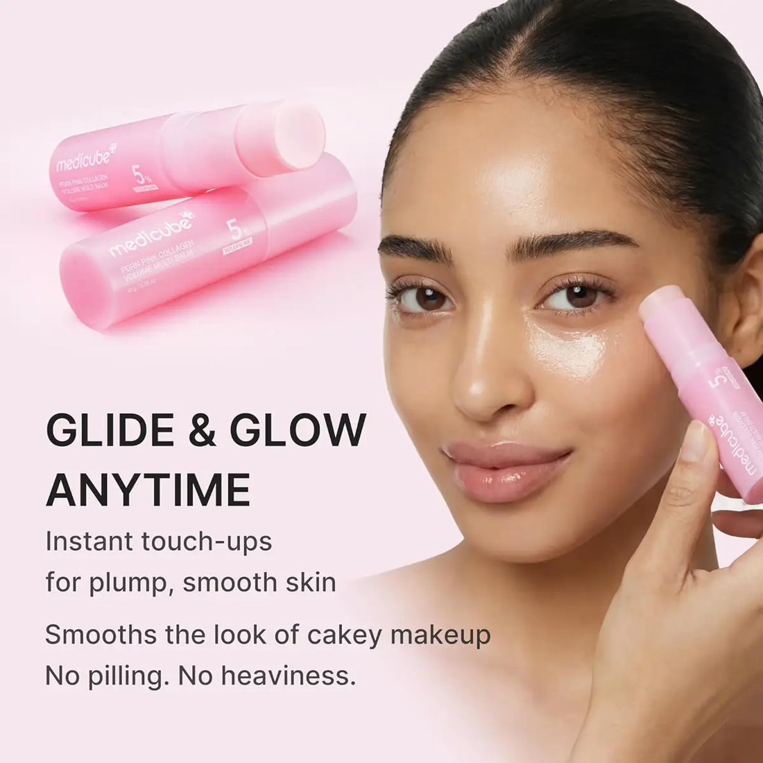 A woman applies a pink MediCube touch-up cosmetic stick to her cheek, with two additional pink sticks shown in the background and promotional text reading 'GLIDE & GLOW ANYTIME'.