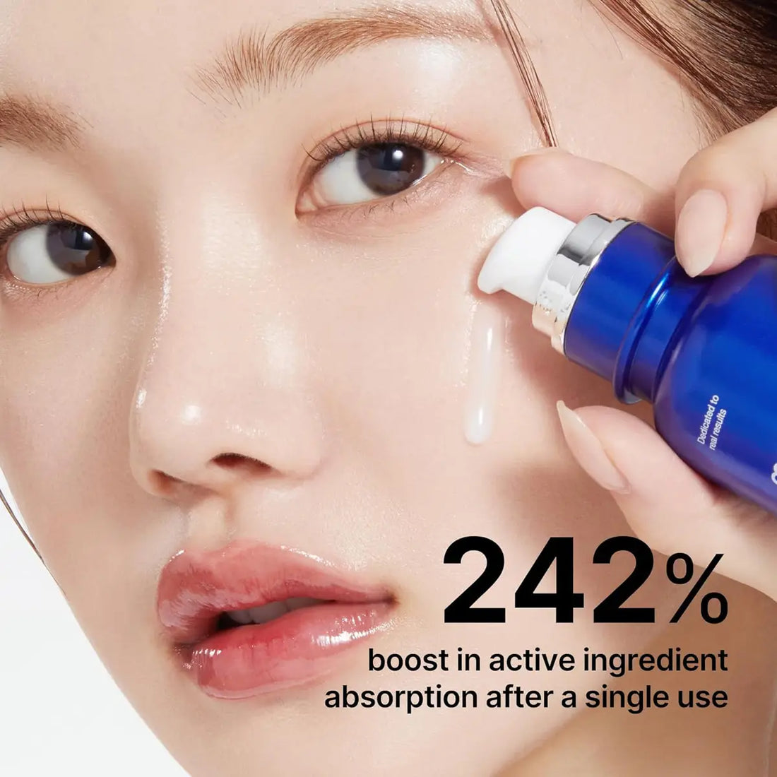 Person applying a blue skincare serum to their face with text about active ingredient absorption.
